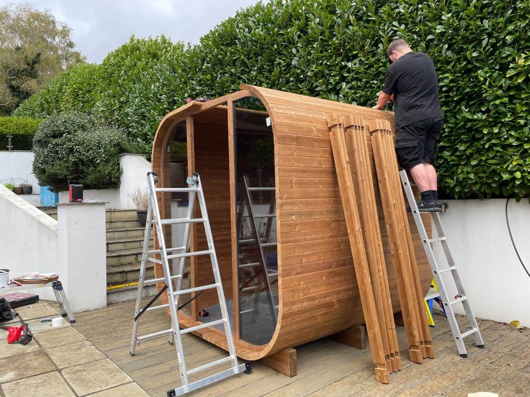 Hyperion Hot Tubs Sauna installer finishing roof section, in Bournemouth.
